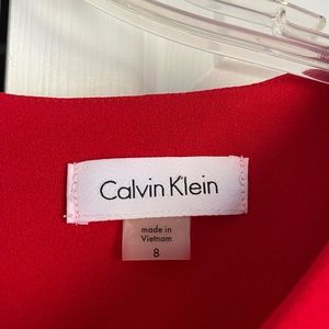 Calvin Klein red size 8 dress with bell sleeves and gold zipper down back